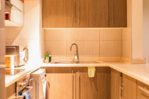a kitchen with a sink and a microwave at Beaufort Ridge - Skysuites in Accra +54 photos