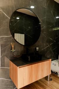 a bathroom with a sink and a mirror at ECO HOTEL RIO DE ORO in San Rafael +49 photos