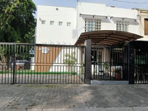 an iron gate in front of a white building at Hotel pasarela real cali in Cali