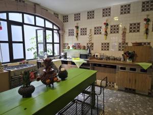 a kitchen with a table with fruits and vegetables on it at Hostel Paricutín in Uruapan del Progreso