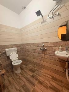 a bathroom with a toilet and a sink at Sukoon e Banaras in Varanasi