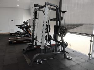 a gym with several tread machines in a room at Departamento 68 river 2 in Guayaquil