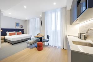 a hotel room with a bed and a sink at Quest Southport in Gold Coast
