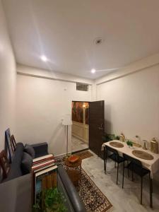 a living room with a couch and a table at Sukoon e Banaras in Varanasi +84 photos