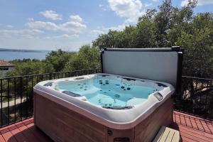 a hot tub on the deck of a balcony at Mountain Trail Retreat in Austin