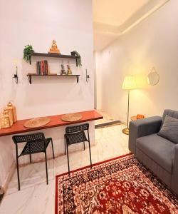 a living room with a table and chairs and a couch at Sukoon e Banaras in Varanasi