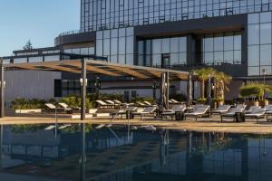 a hotel with a pool and a building at Sheraton Uşak Hotel & Thermal Spa in Uşak