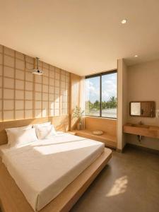 a bedroom with a large bed and a window at Shine Home in Hue