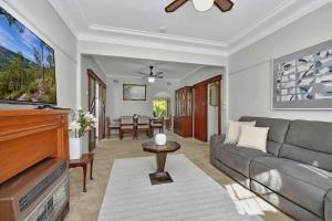 a living room with a couch and a flat screen tv at Morpeth Cottage in Morpeth +11 photos