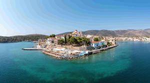 an aerial view of a small island in the water at Kyan Bay in Itea