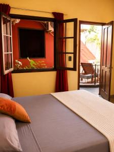 a bedroom with a bed and a window with a patio at JM Resort Iguazu in Puerto Iguazú +32 photos