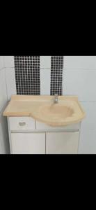 a bathroom sink with a wooden counter top at Casa grande in Serra