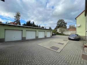 a car parked in a parking lot next to a building at Das grüne Haus in Finsterwalde