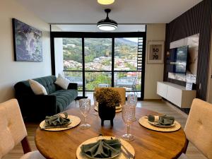 a living room with a table with wine glasses at Panoramic view apartment with Pool and Rooftop in San Salvador