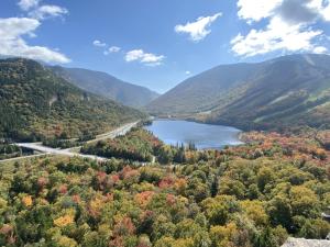 a view of a river in the mountains with trees at Loon Resort Condo-AC, Pool, Hot Tub and Views in Lincoln