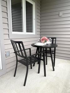 a black table and two chairs on a porch at Loon Resort Condo-AC, Pool, Hot Tub and Views in Lincoln +63 photos
