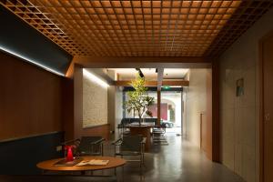 a dining room with tables and chairs and a ceiling at Aura Hotel Purvis in Singapore