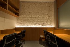 a conference room with wooden tables and chairs at Aura Hotel Purvis in Singapore