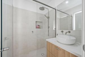 a bathroom with a sink and a glass shower at Inverloch Seaside Escape in Inverloch +11 photos