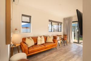 a living room with a couch and a table at Twizel Cottages in Twizel