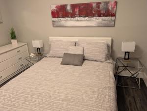 a bedroom with a bed with two end tables and two lamps at Clifton Hill Suite 2202 in Niagara Falls +3 photos