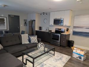 a living room with a couch and a kitchen at Clifton Hill Suite 4401 in Niagara Falls
