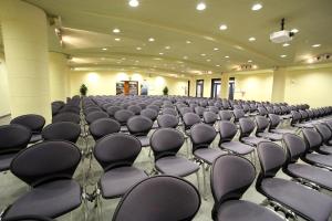 an empty room with rows of chairs in it at Hotel San Rocco in Muggia