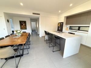 a kitchen and dining room with a table and chairs at Arizons in South West Rocks