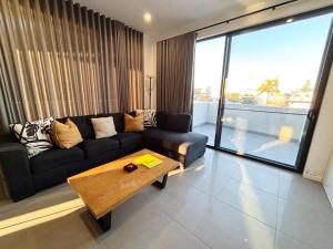 a living room with a couch and a coffee table at Arizons in South West Rocks