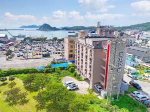 an aerial view of a city with cars parked in a parking lot at Beach Condo Motel in Taean