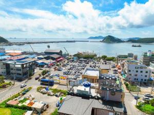 an aerial view of a parking lot next to a body of water at Beach Condo Motel in Taean
