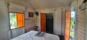 a small bedroom with a bed and a window at The Nest in Cherating