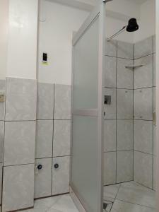 a shower with a glass door in a bathroom at Leo in Copacabana