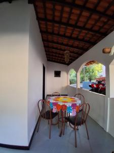 a table and chairs in a room with a balcony at Garden House - Atins in Atins