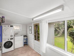 a laundry room with a washer and dryer at River Cottage in Mylestom