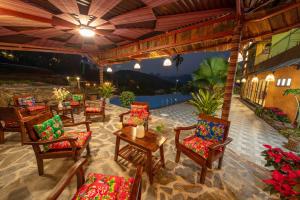 an outdoor patio with chairs and tables with a view at Pu Luong EcoLuxe Resort & Spa in Pu Luong