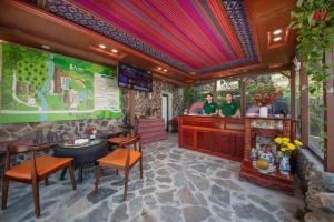 a restaurant with a bar with two people at the counter at Pu Luong EcoLuxe Resort & Spa in Pu Luong