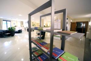 a display of books on a shelf in a room at Hotel San Rocco in Muggia