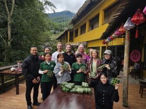 a group of people standing around a table with money at Pu Luong EcoLuxe Resort & Spa in Pu Luong