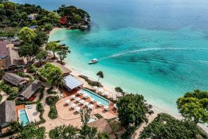an aerial view of a beach with a boat at OUTRIGGER Phi Phi Island Resort in Phi Phi Islands