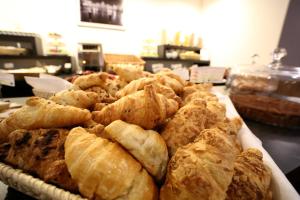 a tray of pastries sitting on top of a table at Hotel San Rocco in Muggia