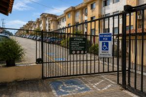 a black gate with a handicapped sign on it at Meu Aconchego - Araruama 2 quartos - Vaga- Wi-Fi in Araruama