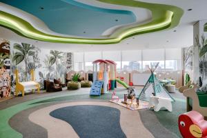 a childrens play room with a slide and swings at Citadines Antasari Jakarta in Jakarta