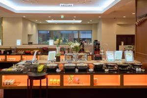 a restaurant with a counter with food on it at Hotel Hokke Club Hakodate in Hakodate