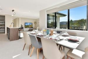 a dining room with a white table and chairs at Mount View Escape at Millfield in Millfield