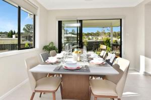 a dining room with a white table and chairs at Mount View Escape at Millfield in Millfield