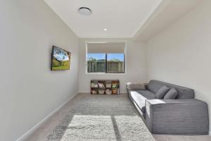 a living room with a couch and a window at Mount View Escape at Millfield in Millfield