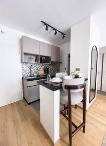 a kitchen with a counter and a table in a room at Capitalcribs in Tatu City