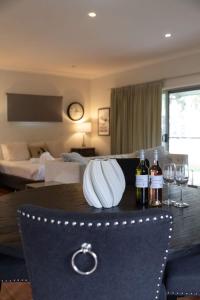 a dining table with two wine glasses and wine bottles at Gartelmann Studio at Gartelmanns Wines in Rothbury