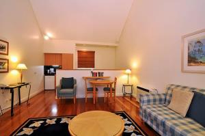 a living room with a couch and a table at Villa 1br Merlot Villa located within Cypress Lakes Resort in Pokolbin